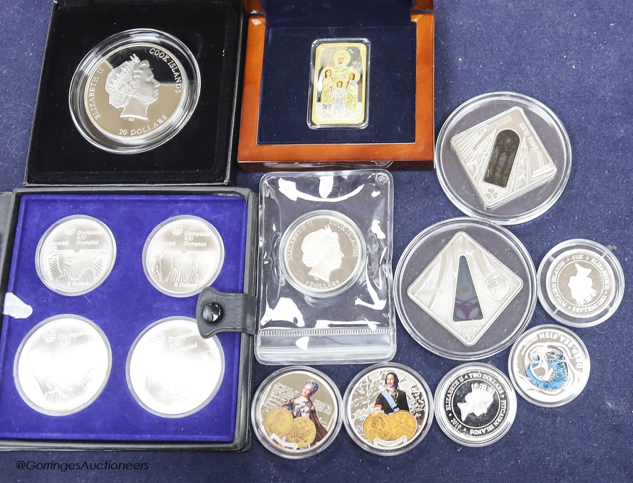 A group of silver proof coins, to include a JVP boxed orthodox shines $2, a Masterpieces of Art Cook Islands $20, a set of 1976 Montréal Olympics coins, a Cook Islands $5, three half ounce silver proof coins, a Niue Isla